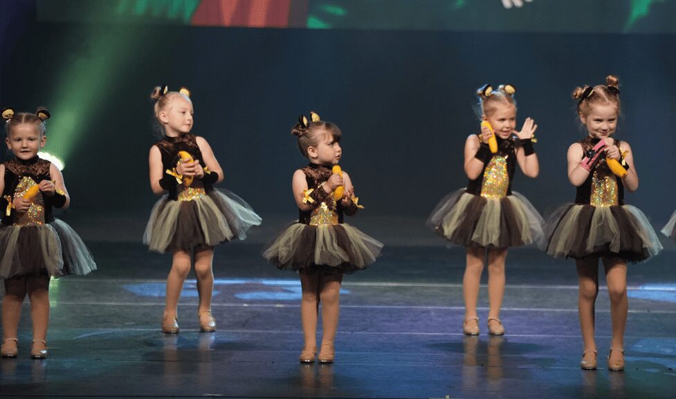 Young performers in glittery bee-themed tutus